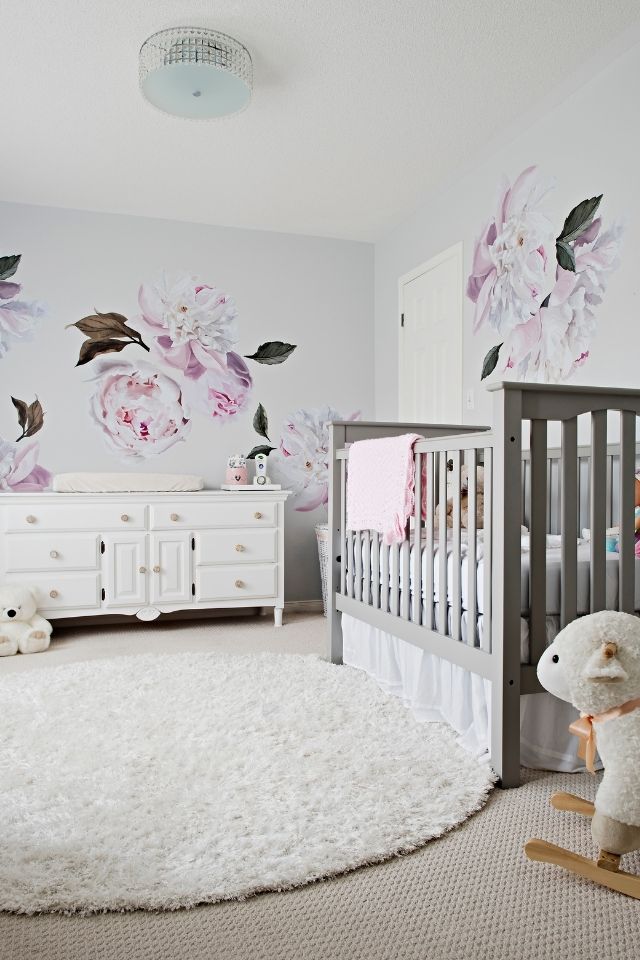 Vintage styled nursery room with flower wallpaper